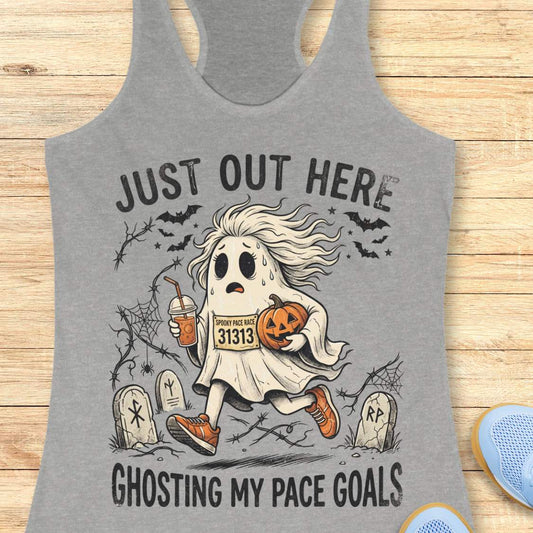 grey Halloween tank top with an image of a running ghost and text 'Just out here ghosting my pace goals', on a wooden surface