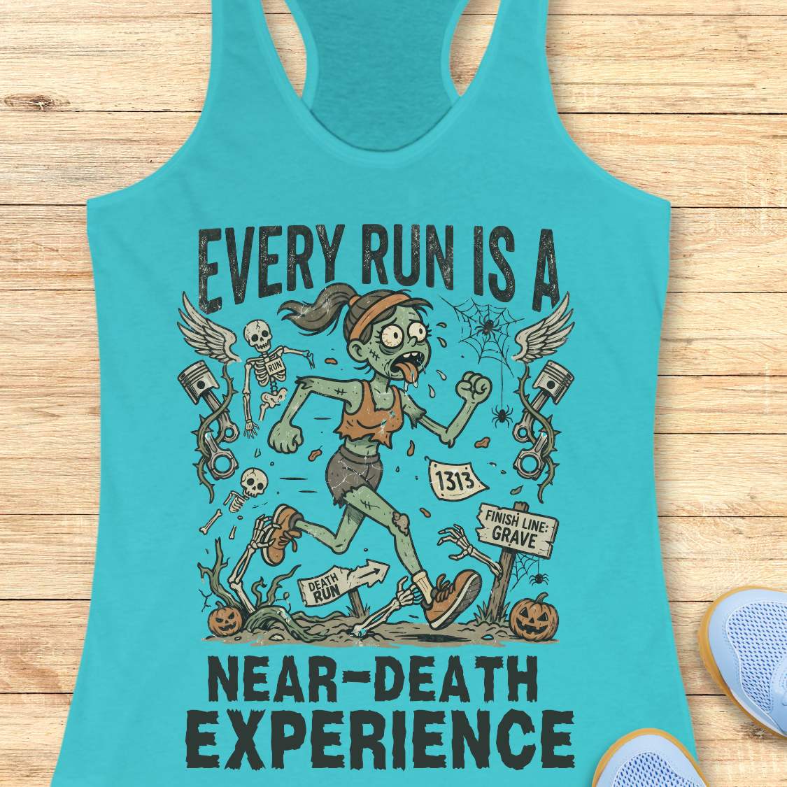 blue Halloween tank top with an image of a running zombie and text 'Every run is a near-death experience', on a wooden surface