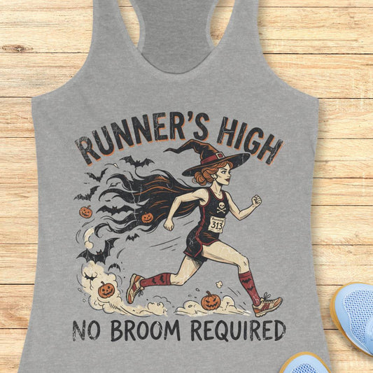 A heather gray racerback tank top laid flat on a light wood surface, featuring a Halloween-themed graphic of a witch running with the text 'RUNNER'S HIGH' and 'NO BROOM REQUIRED'.