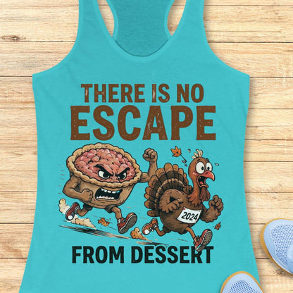 A turquoise racerback tank top laid flat on a light wood surface, featuring a cartoon graphic of a pie and a turkey running, with the text 'THERE IS NO ESCAPE FROM DESSERT.' A partial light blue shoe is visible at the lower right edge.