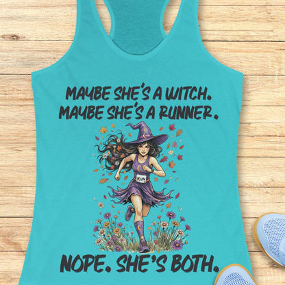 A turquoise racerback tank top laid flat on a light wood surface, featuring a printed graphic of a witch-like woman running through flowers with the text 'MAYBE SHE'S A WITCH. MAYBE SHE'S A RUNNER.