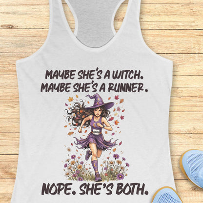 A white racerback tank top with a graphic print of a female runner dressed as a witch, surrounded by autumn leaves and flowers. The text reads 'MAYBE SHE'S A WITCH.