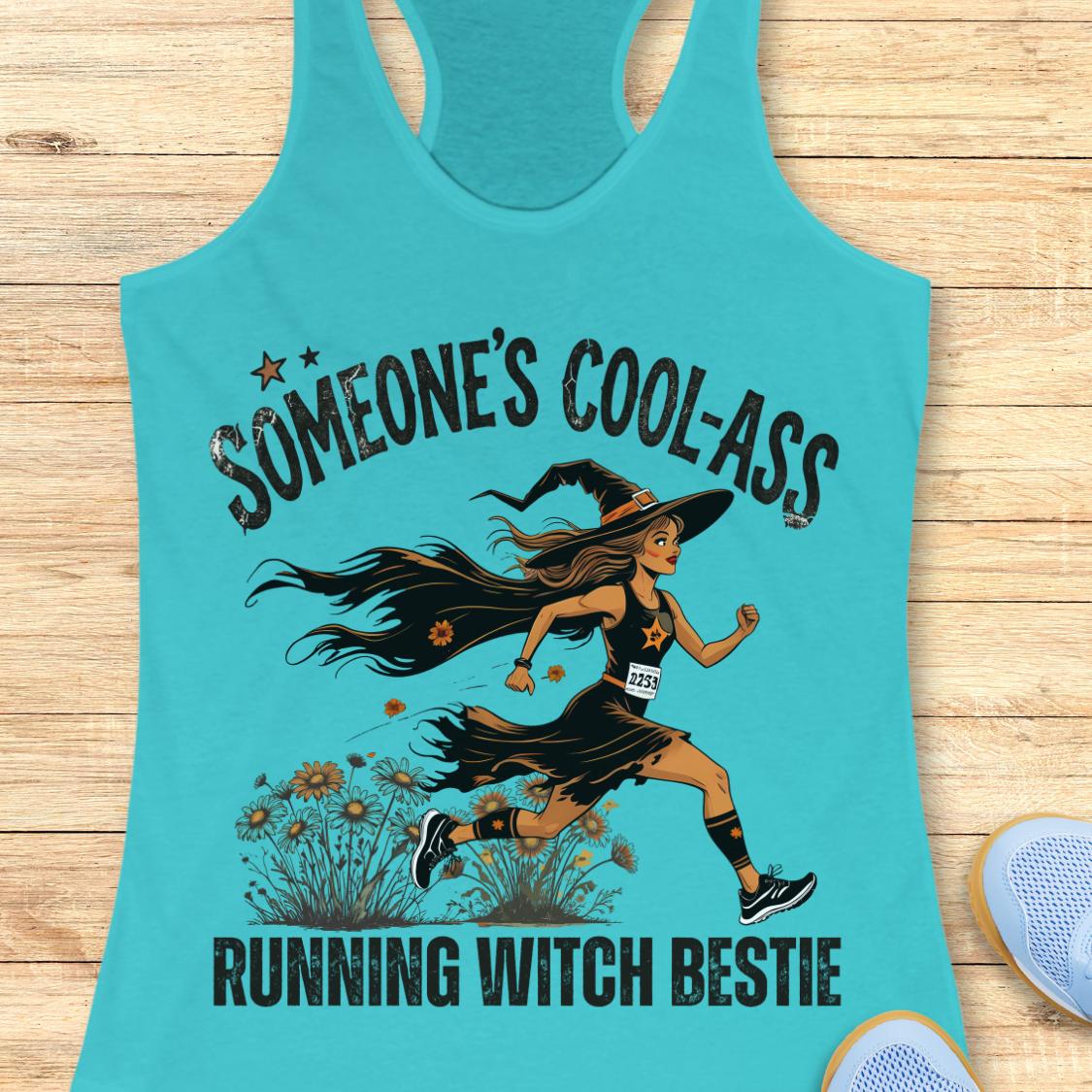 A turquoise racerback tank top laid flat on a light wood surface, featuring a graphic of a witch running with the text 'SOMEONE'S COOL-ASS RUNNING WITCH BESTIE'.