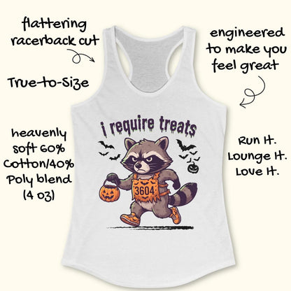 A racerback tank top shown on a light cream background with decorative text callouts around it. The tank is white and features a large front graphic of a raccoon in a Halloween costume holding a pumpkin, with the phrase 'i require treats' above it.
