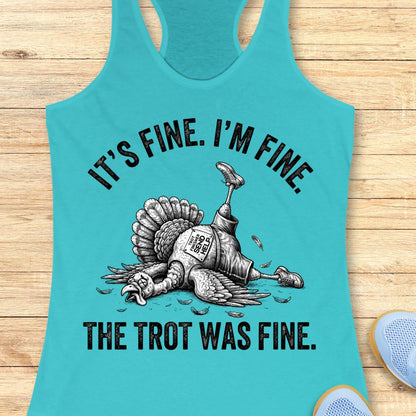A turquoise racerback tank top laid flat on a light wood surface, featuring a black graphic of a turkey with a bottle neck and the text 'IT'S FINE. I'M FINE.