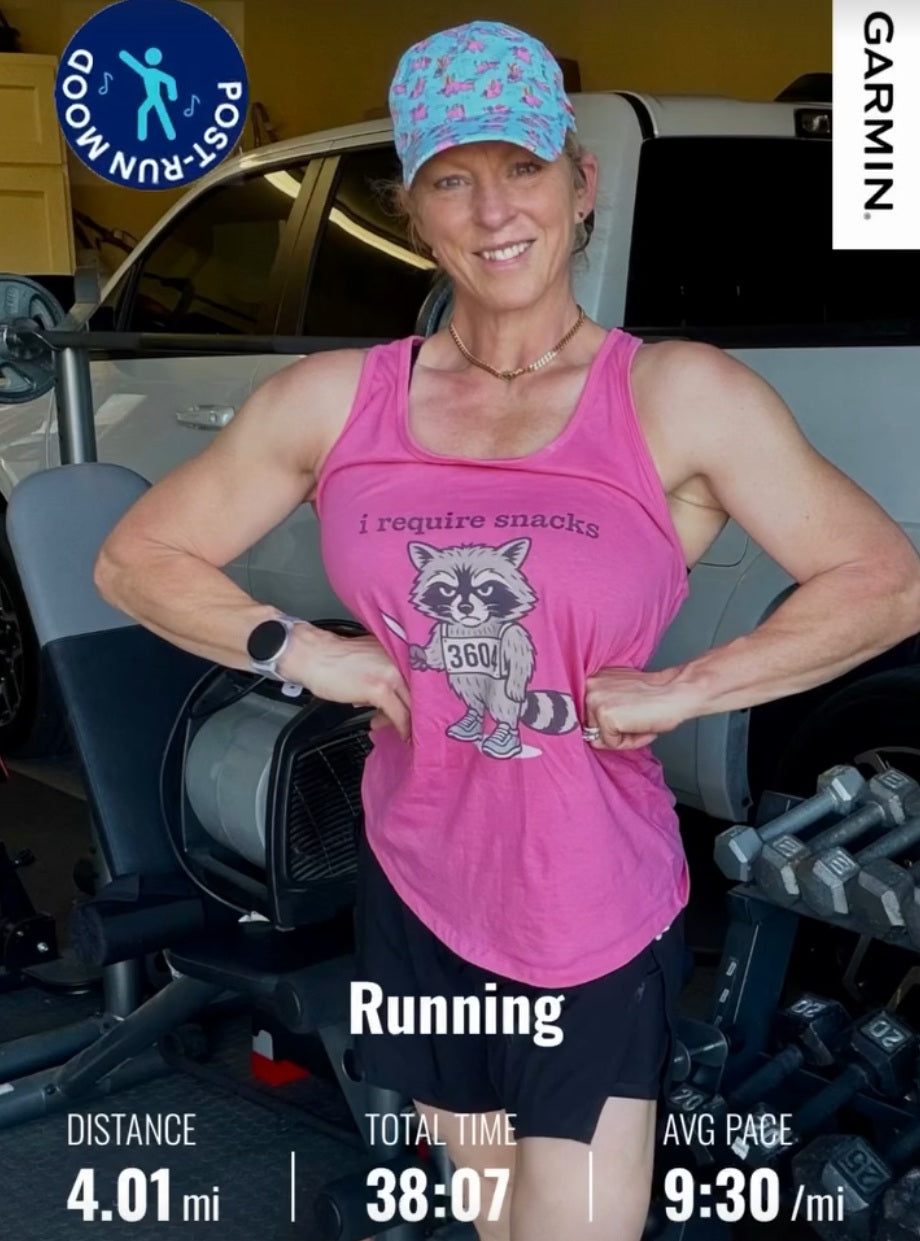 A woman runner wearing a pink tank top with the text- " i require snacks" with an image of an angry and hungry raccoon