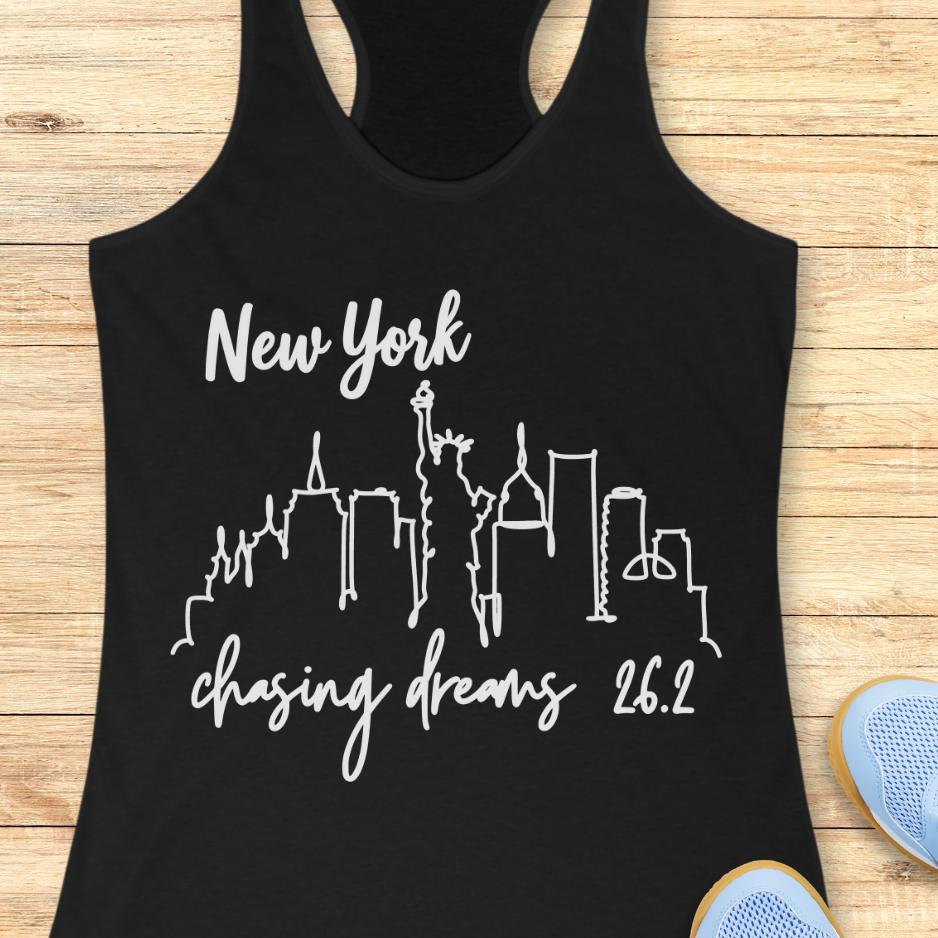 black tank top with new york skyline and text - New York, chasing dreams 262., on a wooden background