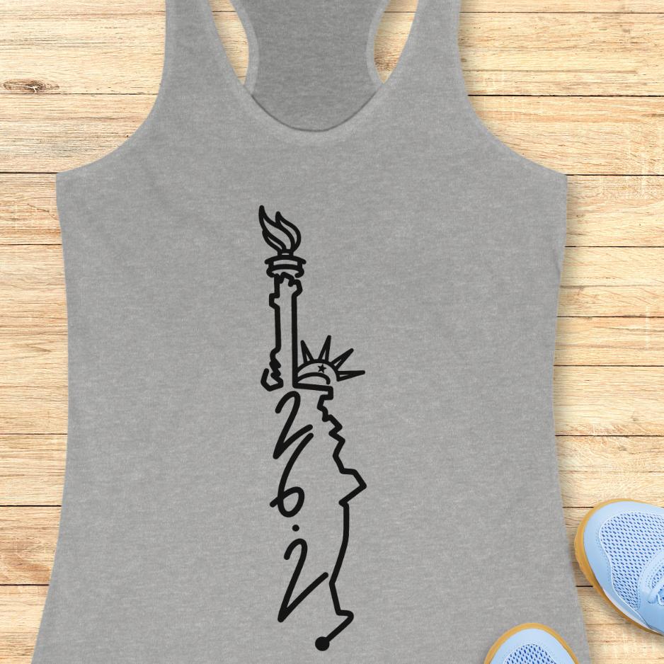 grey tank top with an image of lady liberty and the number 26.2 with a wooden background