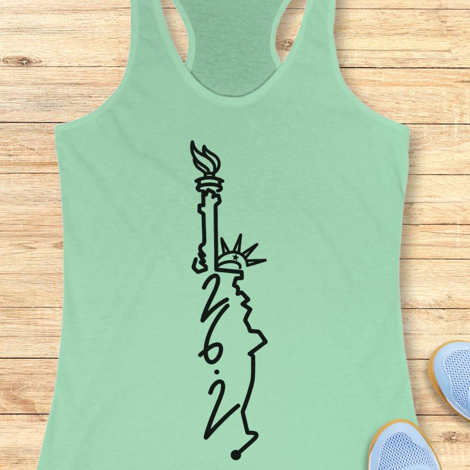 mint  tank top with an image of lady liberty and the number 26.2 with a wooden background