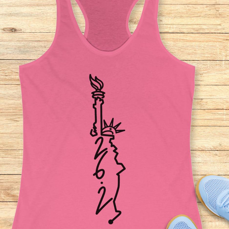 pink tank top with an image of lady liberty and the number 26.2 with a wooden background