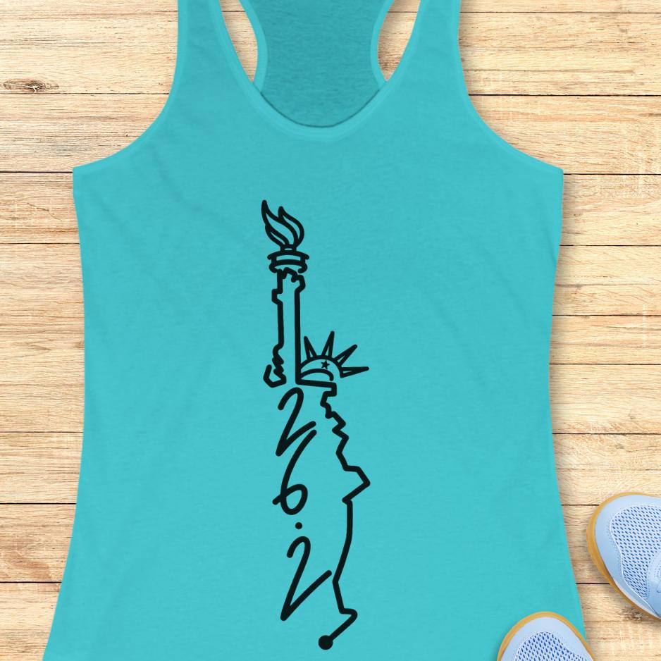blue tank top with an image of lady liberty and the number 26.2 with a wooden background