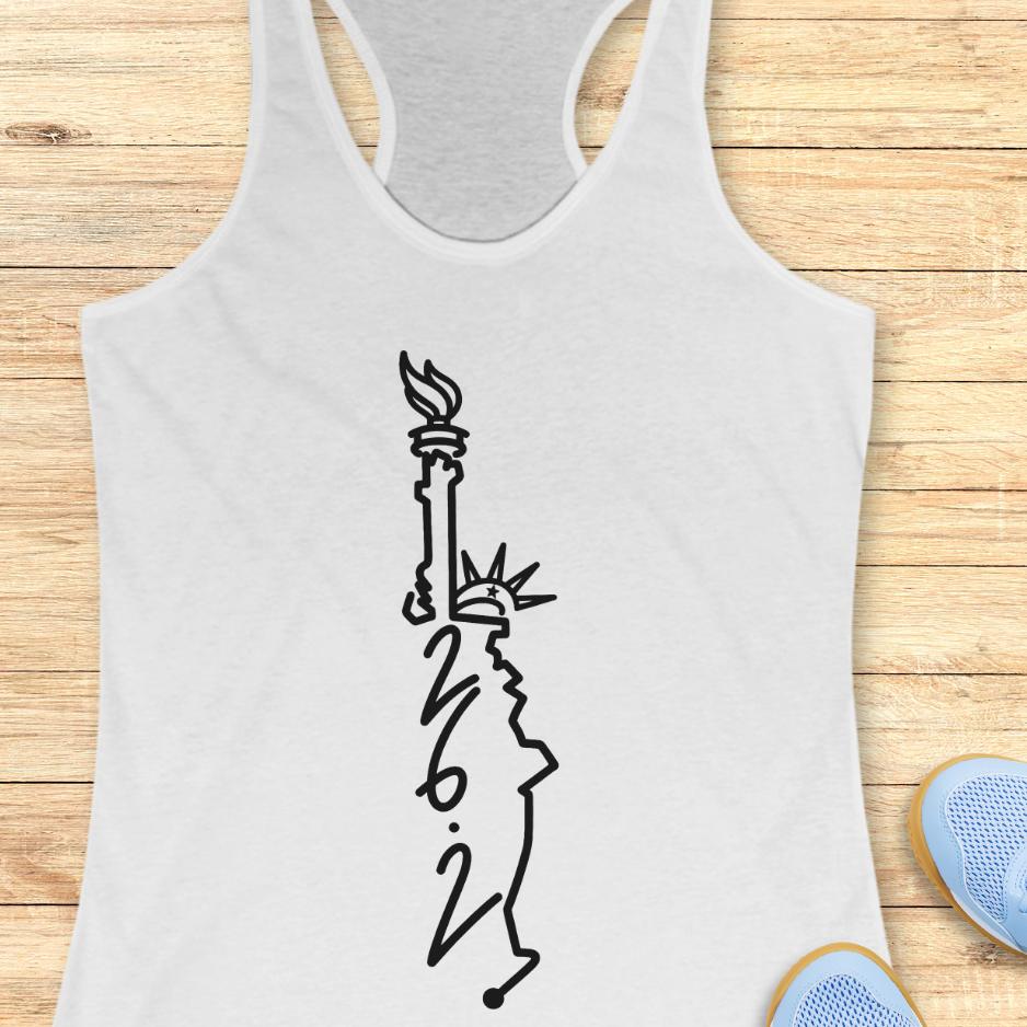 white tank top with an image of lady liberty and the number 26.2 with a wooden background