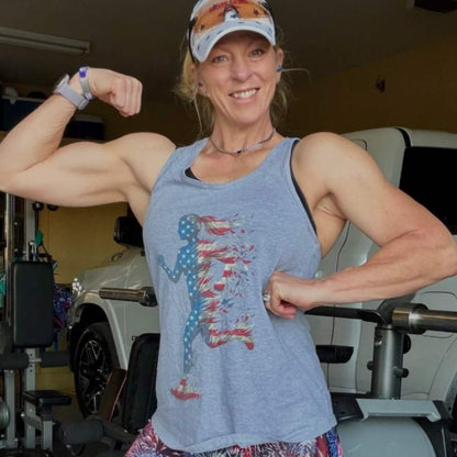 A woman runner wearing a heather grey tank top with a graphic design of an American runner