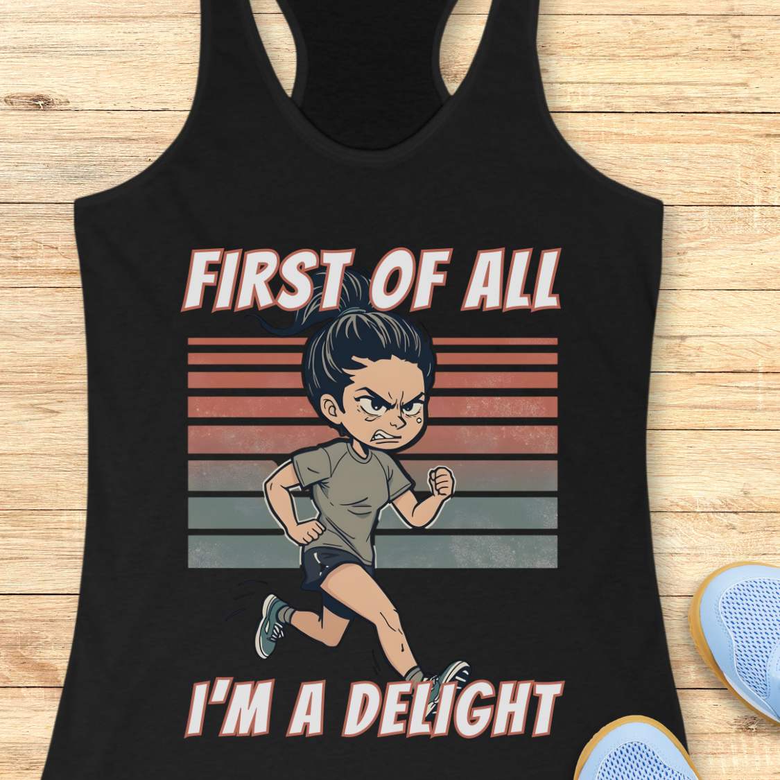 Black tank top with a graphic of a character running and text 'First of all I'm a delight' on a wooden surface.