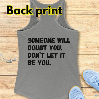 a grey tank op with a text at the back of the tank top "Someone will doubt you. Don't let it be you." on a wooden background