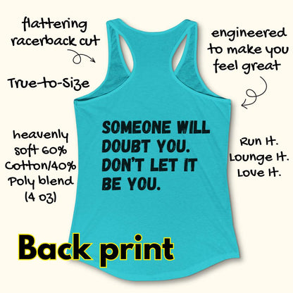 a blue tank op with a text at the back of the tank top "Someone will doubt you. Don't let it be you." on a wooden background