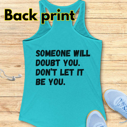 a blue tank op with a text at the back of the tank top "Someone will doubt you. Don't let it be you." on a wooden background