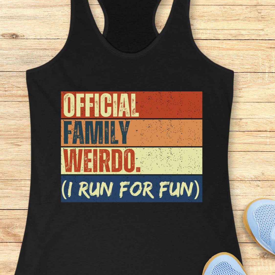 Black tank top with colorful text design, a vibrant retro color block design featuring red orange yellow and blue stripes emblazoned with the text OFFICIAL FAMILY WEIRDO (I RUN FOR FUN) on a wooden surface
