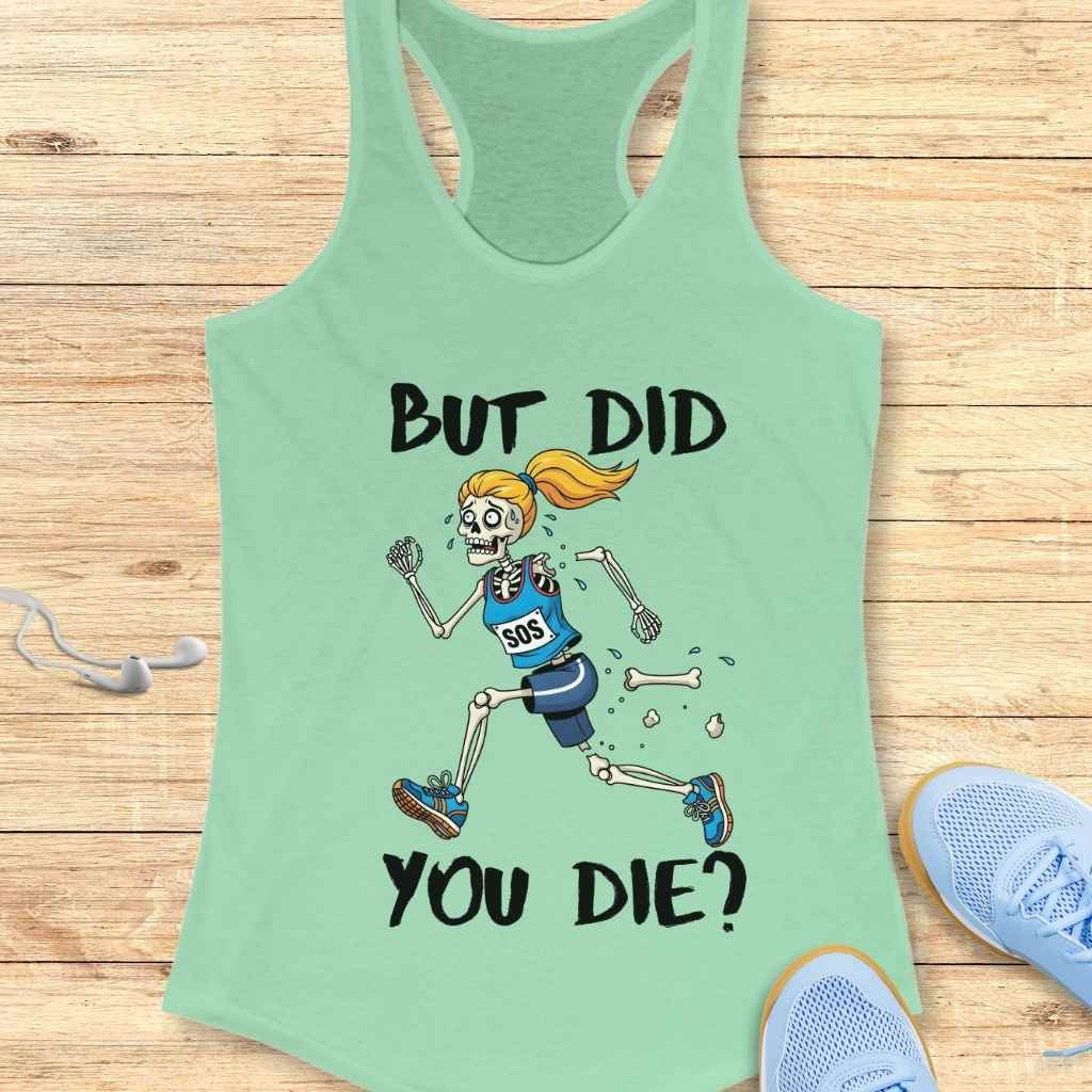 Digital illustration on a mint green racerback tank top showing a cartoon female skeleton runner with a blonde ponytail and blue "SOS" outfit, sweating profusely and losing bones, accompanied by the bold text BUT DID YOU DIE, all laid out on a wooden surface with white earbuds and blue sneakers