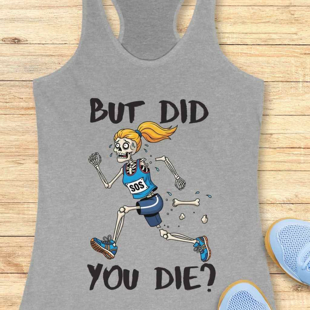 Gray tank top featuring a cartoon illustration of a terrified female skeleton runner with an orange ponytail, wearing a blue "SOS" top and shorts, shedding bones as she runs, accompanied by the bold text BUT DID YOU DIE, laid on a light wood background with partially visible light blue athletic shoes