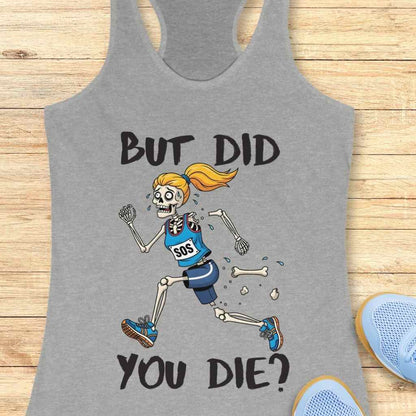 Gray tank top featuring a cartoon illustration of a terrified female skeleton runner with an orange ponytail, wearing a blue "SOS" top and shorts, shedding bones as she runs, accompanied by the bold text BUT DID YOU DIE, laid on a light wood background with partially visible light blue athletic shoes