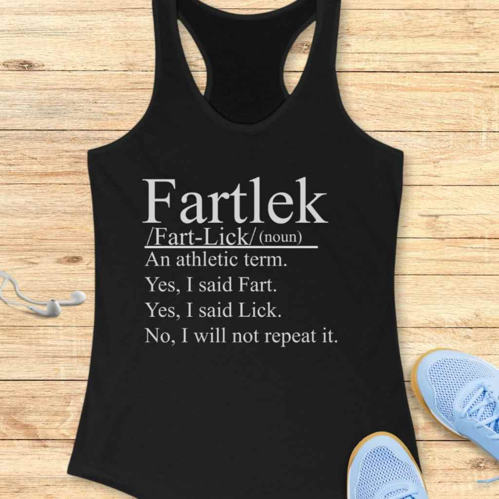 Black athletic tank top featuring white text defining 'Fartlek' as an athletic term with the humorous breakdown 'Yes, I said Fart. Yes, I said Lick. No, I will not repeat it,' displayed on a wooden surface alongside light blue running shoes and white earbuds
