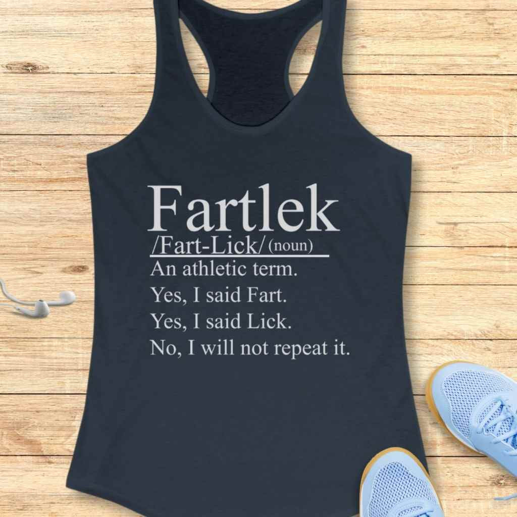 Product photo of a dark blue women's athletic tank top featuring white text humorously defining "Fartlek" on a light wooden surface, with white wired earbuds and light blue running shoes visible