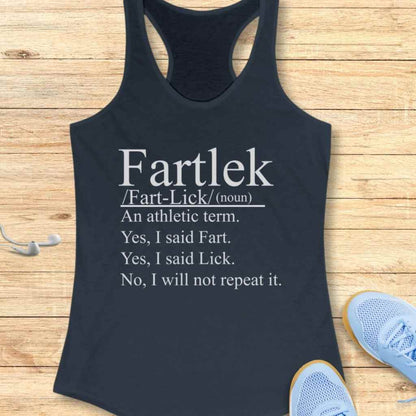 Product photo of a dark blue women's athletic tank top featuring white text humorously defining "Fartlek" on a light wooden surface, with white wired earbuds and light blue running shoes visible