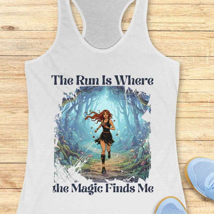 Graphic print on a white tank top featuring an animated woman with flowing red hair running down a path through an ethereal blue-green magical forest with glowing mushrooms and light, accompanied by the text "The Run Is Where the Magic Finds Me"