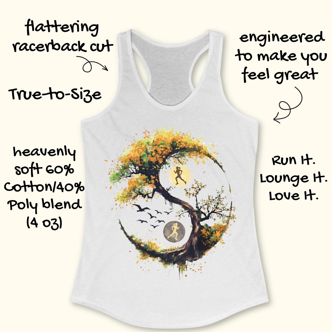 A white racerback tank top laid flat on a light wood surface, featuring a large graphic of a stylized tree with autumn leaves in yellow, orange, and brown, integrated with a running yin-yang symbol showing two running figures and birds.
