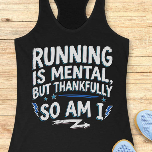 A black racerback tank top laid flat on a light wood background, featuring a distressed white graphic with blue shadowing that reads, 'RUNNING IS MENTAL, BUT THANKFULLY SO AM I.' Partial blue sneakers are visible at the bottom right as styling props.