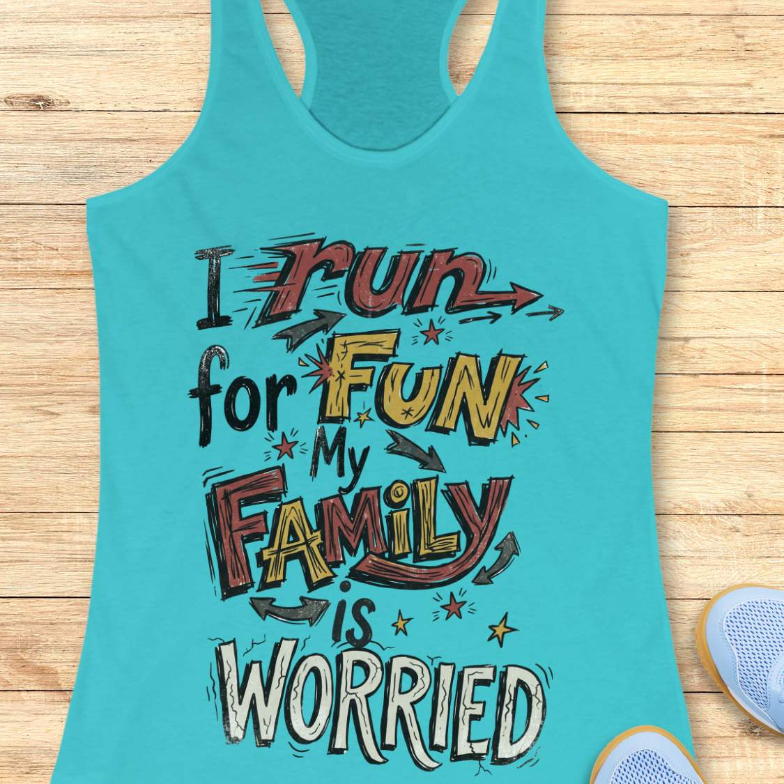 A turquoise racerback tank top laid flat on a light wood background, featuring a colorful graphic text that reads 'I run for FUN My FAMILY is WORRIED' in stylized lettering. Partial shoes are visible at the bottom right as styling props.