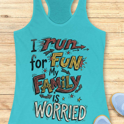 A turquoise racerback tank top laid flat on a light wood background, featuring a colorful graphic text that reads 'I run for FUN My FAMILY is WORRIED' in stylized lettering. Partial shoes are visible at the bottom right as styling props.