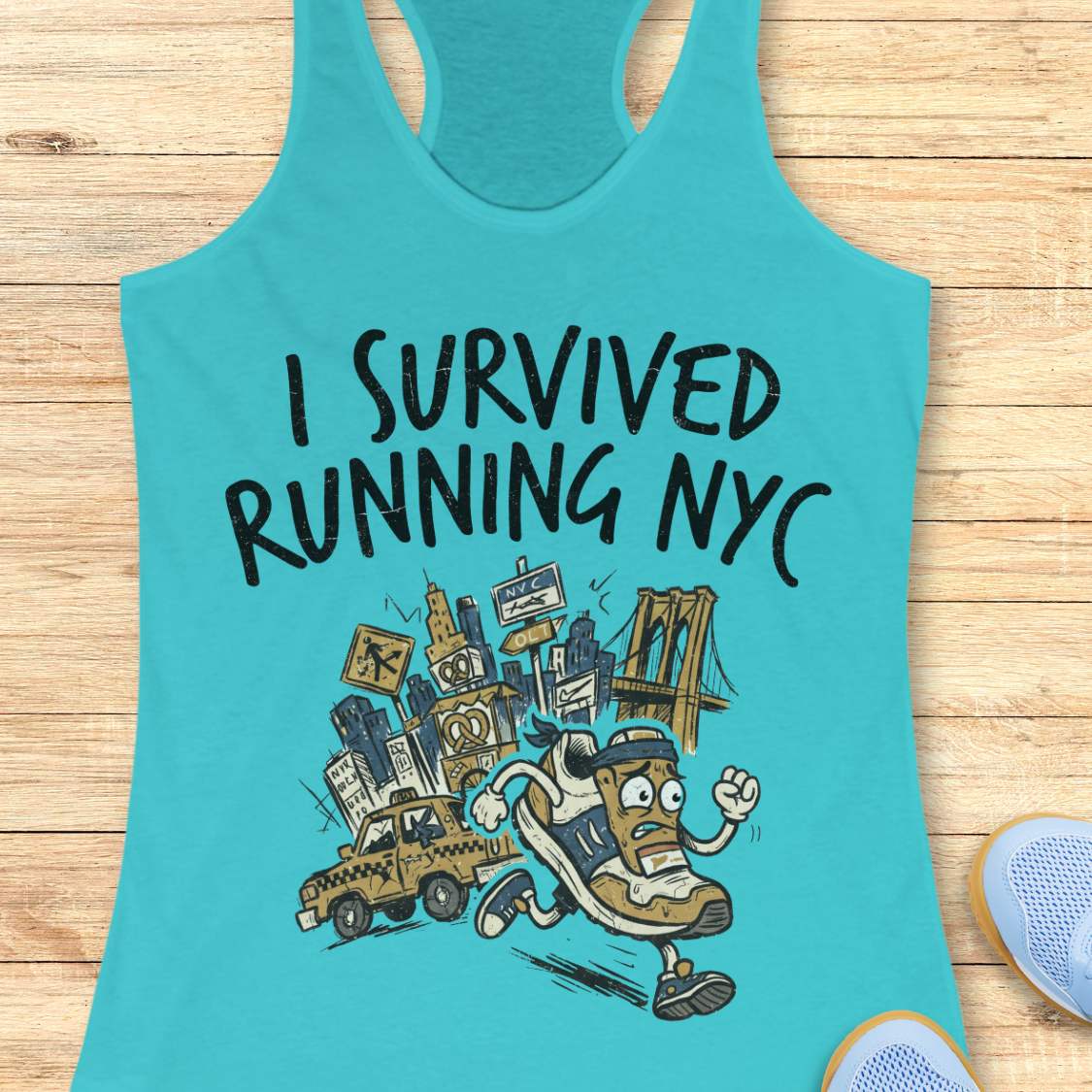 A turquoise racerback tank top laid flat on a light wood surface, featuring a graphic print that reads 'I SURVIVED RUNNING NYC' above an illustrated cartoon runner, city skyline, bridge, and taxi.