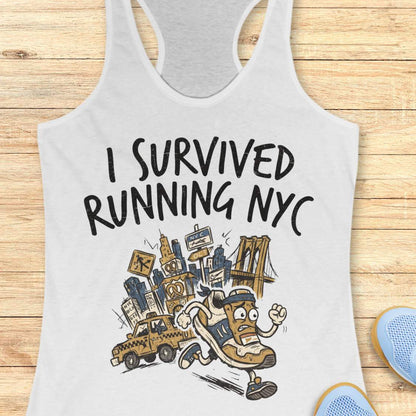 A white racerback tank top laid flat on a light wood plank background, featuring a graphic print that reads 'I SURVIVED RUNNING NYC' above an illustrated character running with a city skyline, taxi, and bridge.