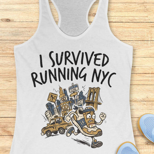 A white racerback tank top laid flat on a light wood plank background, featuring a graphic print that reads 'I SURVIVED RUNNING NYC' above an illustrated character running with a city skyline, taxi, and bridge.