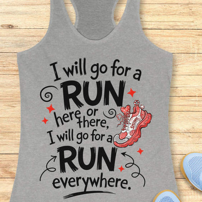 A grey racerback tank top laid flat on a light wood plank background, featuring a graphic print that reads 'I will go for a run here or there, I will go for a run everywhere.' with an illustrated of a red running shoe.