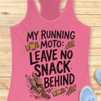 A pink racerback tank top laid flat on a light wood background, featuring a black hand-drawn style graphic that reads 'MY RUNNING MOTO: LEAVE NO SNACK BEHIND' with illustrations of a winged running shoe, a slice of pizza, a lightning-bolt snack bar, and a small crown.
