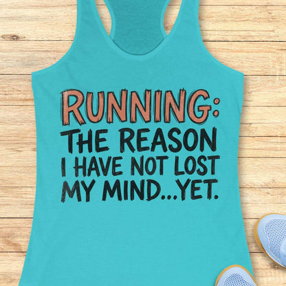 A turquoise racerback tank top laid flat on a light wood surface, printed with the phrase 'RUNNING: THE REASON I HAVE NOT LOST MY MIND.