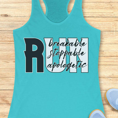 A turquoise racerback tank top laid flat on a light wood plank background, featuring a graphic print that reads 'RUN' with 'breakable stoppable apologetic' in black script and block lettering. Partial sneakers are visible at the bottom right as styling props.