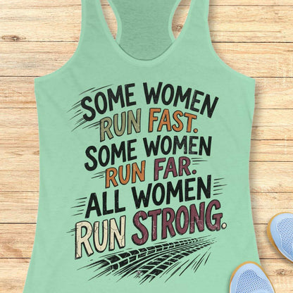 A mint racerback tank top laid flat on a light wood surface, featuring a motivational graphic with illustrated sneakers.