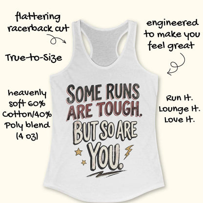 A white racerback tank top laid flat on a light wood surface, featuring a motivational graphic with illustrated sneakers.