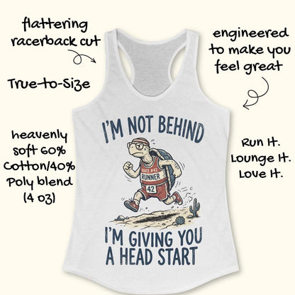 A white racerback tank top with a graphic of a turtle runner and the text 'I'M NOT BEHIND I'M GIVING YOU A HEAD START'. Handwritten promotional text surrounds the shirt on a light beige background.