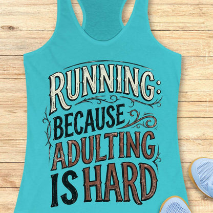 A turquoise racerback tank top laid flat on a light wood surface, printed with the phrase “RUNNING BECAUSE ADULTING IS HARD” in large decorative lettering. Partial light blue sneakers are visible at the lower right edge.
