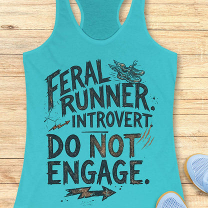 A turquoise racerback tank top laid flat on a light wood surface, featuring distressed black text that reads 'FERAL RUNNER. INTROVERT. Do not engage.'