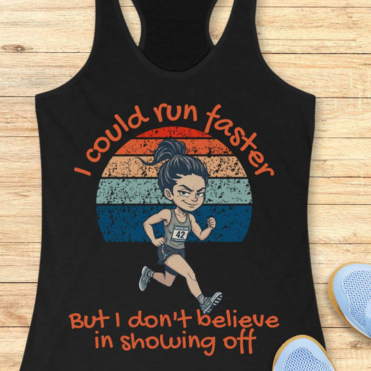 Black racerback tank top featuring a humorous running-themed design with the phrase, “I could run faster but I don't believe in showing off.” The graphic includes a cartoon-style runner wearing a race bib and running in front of a distressed retro sunset made of orange, cream, light blue, and dark blue stripes. The playful typography and vintage-inspired colors create a fun design for runners with a sense of humor.