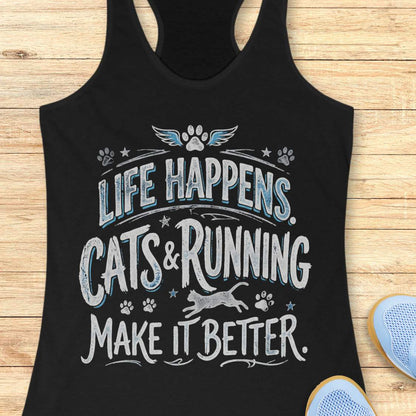 A black racerback tank top laid flat on a light wood surface, featuring a distressed graphic that reads 'LIFE HAPPENS. CATS & RUNNING MAKE IT BETTER.