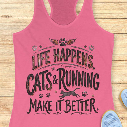 A pink racerback tank top laid flat on a light wood background, featuring a distressed black graphic that reads 'LIFE HAPPENS. CATS & RUNNING MAKE IT BETTER.