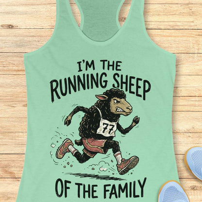 A mint green racerback tank top laid flat on a light wood background, featuring a cartoon illustration of a running sheep wearing a race bib number 77 and the text 'I'M THE RUNNING SHEEP OF THE FAMILY'.