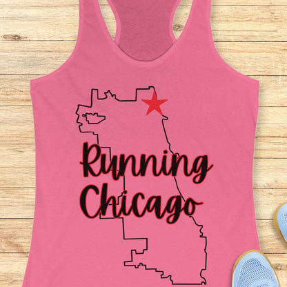 pink racerback running tank top featuring a minimalist white outline of the city of Chicago. A large red six-pointed star, inspired by the Chicago flag, marks a location near the upper right section of the city outline. The words “Running Chicago” appear in large script lettering layered over the map design. The tank top is displayed on a light wood background with partial blue running shoes visible in the bottom corners. The design has a clean, modern look celebrating running in Chicago.